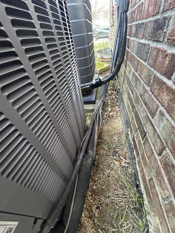 Successfully replaced customer's outdoor AC unit under warranty. Installed new Daikin equipment in the existing location between brick wall and building exterior, ensuring proper positioning and connection of all refrigerant lines and electrical components. Unit is now operational and warranty service is complete.