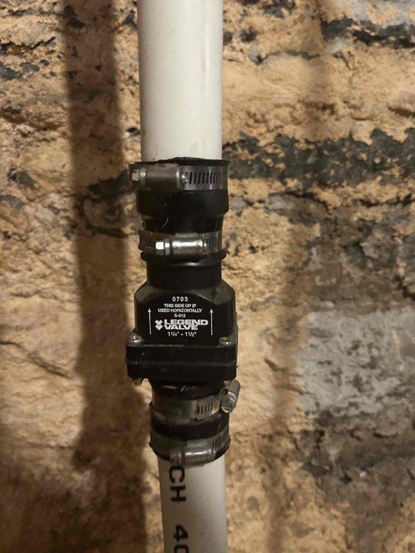 Responded to service call for sump pump repair. Found broken discharge pipe requiring reattachment. Installed new PVC pipe with Legend model 0703 coupling (1¼" - 1½") secured with metal hose clamps to reconnect the discharge line from sump pump to outside drainage, successfully resolving basement water leakage issue.