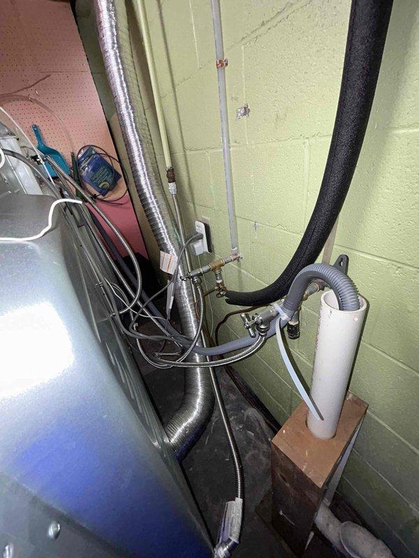 Performed routine plumbing inspection of facility's utility area, examining all visible piping systems including PVC, black insulated pipes, and connection points. Tested shower fixture functionality, confirming proper water flow and pressure through the stainless steel handheld shower head. All plumbing systems were found to be in normal working condition with no visible leaks or deterioration.