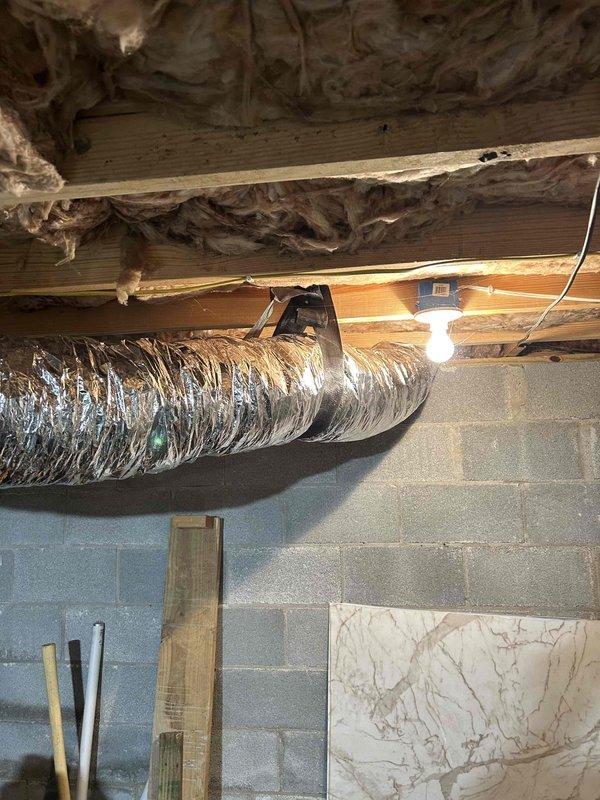 Completed installation of 7" R6 insulated flex duct with proper connections including a 7" round-to-round fitting and a new 6"x12" boot. Finalized the installation with a new 6"x12" floor register in the finished area, resolving airflow issues in the space.