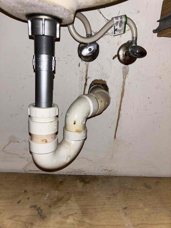 Conducted a PSA plumbing inspection, examining sink drain assembly components and P-trap connections. Identified minor water staining around wall penetrations. Also inspected basement/crawl space area where evidence of moisture intrusion was observed at the foundation wall-floor junction, with visible efflorescence and water staining on cinder block walls.