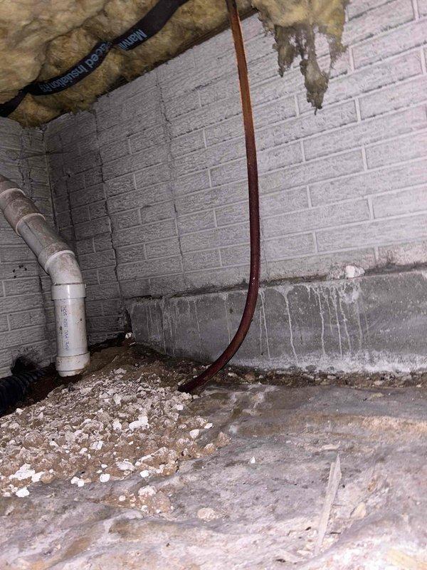 Conducted a PSA plumbing inspection, examining sink drain assembly components and P-trap connections. Identified minor water staining around wall penetrations. Also inspected basement/crawl space area where evidence of moisture intrusion was observed at the foundation wall-floor junction, with visible efflorescence and water staining on cinder block walls.