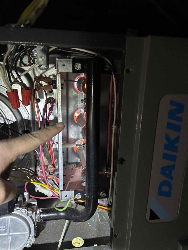 Performed scheduled Care Plan tune-up on dual Goodman HVAC system (2 furnaces/2 AC units) with one furnace located in attic. Inspected Daikin unit's electrical connections, finding all wire nuts secure and properly connected to control board. Examined igniter rod and heat exchanger components, noting normal wear with minor dust accumulation but no significant corrosion requiring immediate attention.