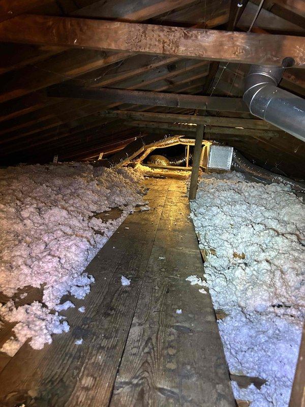 Performed diagnostic on 20-year-old gas furnace system experiencing temperature control issues (set point 70°F, actual 67°F) with reported inability to shut off. Inspection revealed significant airflow restrictions caused by excessive vegetation growth around outdoor condenser unit and disturbed/improperly distributed insulation in attic near indoor unit. Cleared vegetation debris, properly redistributed attic insulation, and serviced control board to restore normal thermostat communication. System now maintaining set temperature with proper cycling.
