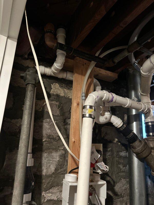 Conducted evaluation of non-compliant sump pump system in basement that currently drains into sewer line. Inspected existing plumbing infrastructure, including PVC and metal piping connections, to determine optimal relocation solution for 14-15 year old pump system. Prepared quote for homeowner to bring installation up to current code requirements.