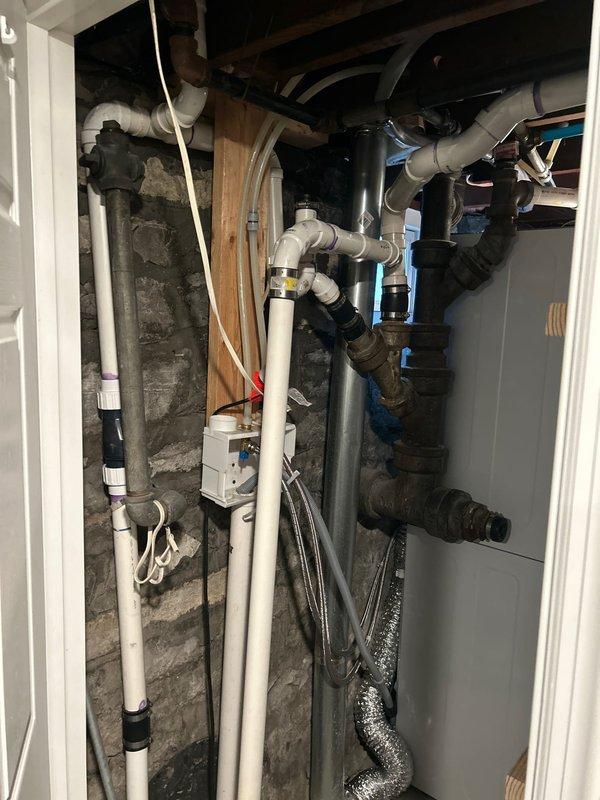 Conducted evaluation of non-compliant sump pump system in basement that currently drains into sewer line. Inspected existing plumbing infrastructure, including PVC and metal piping connections, to determine optimal relocation solution for 14-15 year old pump system. Prepared quote for homeowner to bring installation up to current code requirements.