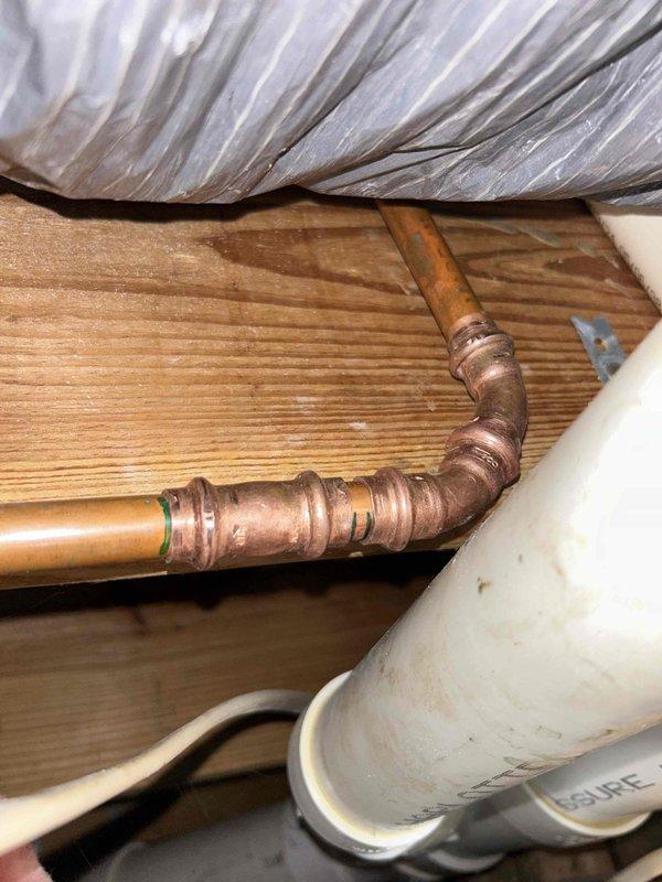 Located and repaired leak in first floor bathroom, originating from vent fixture. Investigation revealed copper pipe joints with signs of aging and steady dripping that had caused ceiling discoloration. Replaced damaged pipe sections and checked surrounding PVC connections to ensure complete resolution of the issue.