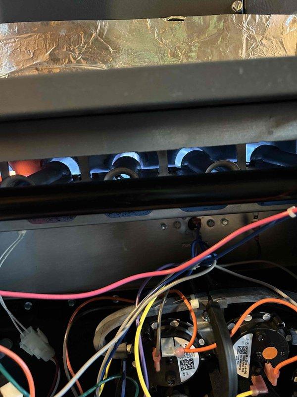 Performed scheduled Care Plan tune-up on customer's gas furnace and heat pump system. Conducted full inspection and operational testing with multimeter showing proper voltage readings (493.8V) across electrical components. Verified proper flame pattern and combustion in burner assembly. Customer was provided with requested quote for UV light replacement.