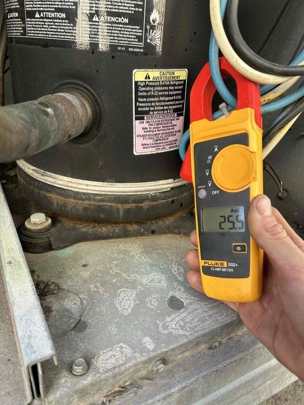 Responded to no heat call for electric HVAC system approximately 3 years old located on rooftop. Conducted electrical diagnostic testing using Fluke 902 FC and Fluke 302+ clamp meters to measure amperage readings on system components, revealing readings of 64.3 and 25.5 respectively. System restored to proper operation after addressing electrical issues causing the fan failure.
