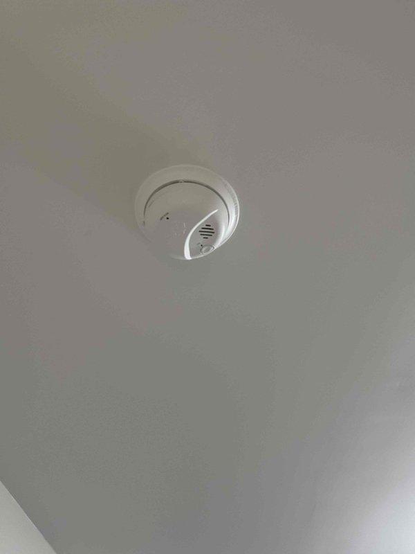 Successfully completed installation of 5 hardwired smoke detectors throughout the residence, replacing outdated units with modern sealed models featuring extended battery life. All units were properly mounted flush to ceiling surfaces and tested to ensure proper operation.