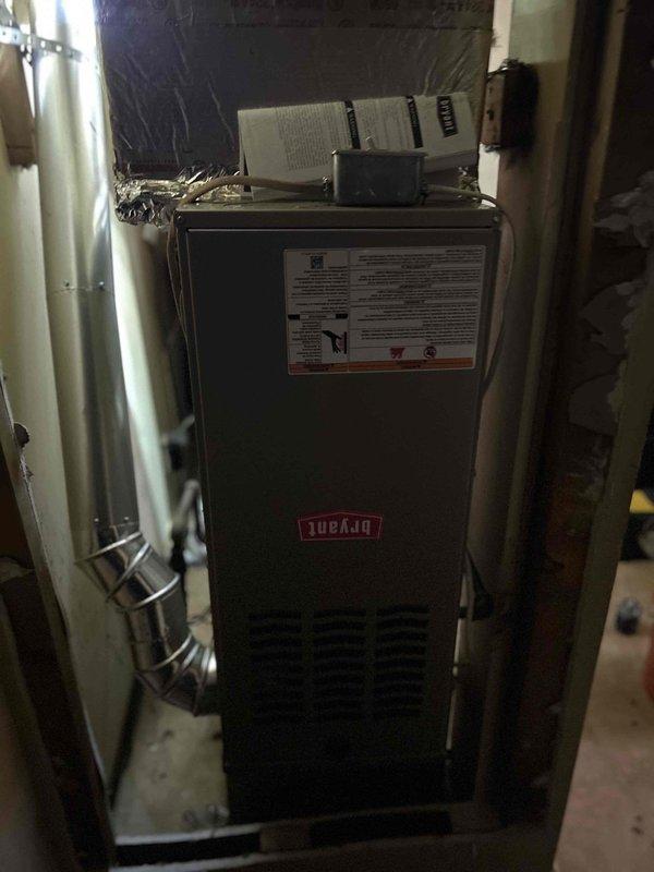 Successfully installed a Bryant 80% efficient single-stage furnace (800SB36070M14, 70,000 BTU) in the client's residence, positioning the unit in the opposite direction facing the hallway as requested. Connected the system to the existing thermostat and flue piping, and installed all required safety components including electrical/gas shut-off switches, flame roll-out protection, and flexible gas line connector.