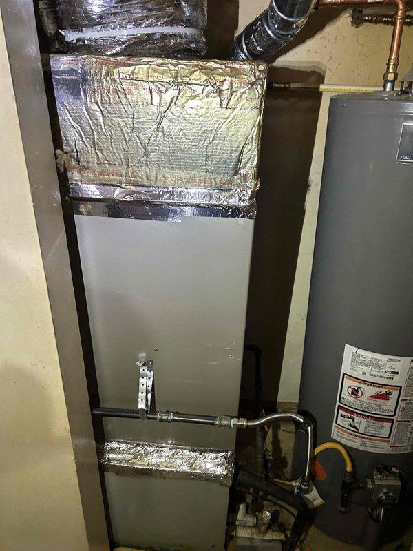 Successfully installed a Bryant 80% efficient single-stage furnace (800SB36070M14, 70,000 BTU) in the client's residence, positioning the unit in the opposite direction facing the hallway as requested. Connected the system to the existing thermostat and flue piping, and installed all required safety components including electrical/gas shut-off switches, flame roll-out protection, and flexible gas line connector.