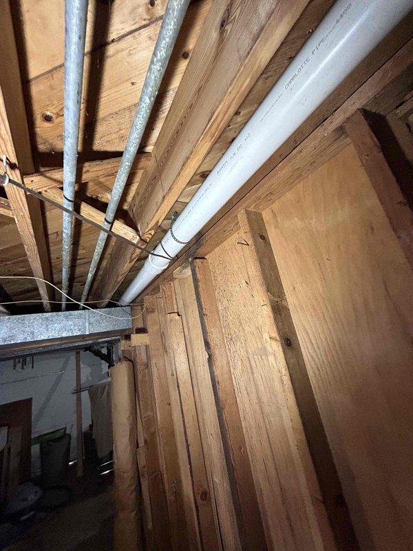 Completed replacement of deteriorated cast iron drain system with new PVC piping throughout bathroom, including shower, sink, and toilet drain lines. Installed new toilet flange and created access point to remove galvanized drain behind sink. New toilet successfully installed and tested for proper drainage.