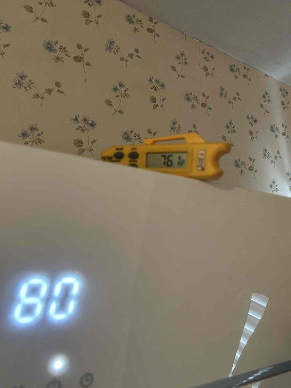 Performed scheduled Care Plan Tune Up on customer's HVAC system. Ambient temperature readings showed 76.6°F on measurement device with thermostat setting at 80°F. Identified ductwork issue in mechanical room with disconnected circular duct and exposed yellow insulation material at HVAC unit connection point. Reattached and properly sealed ductwork to restore system integrity.