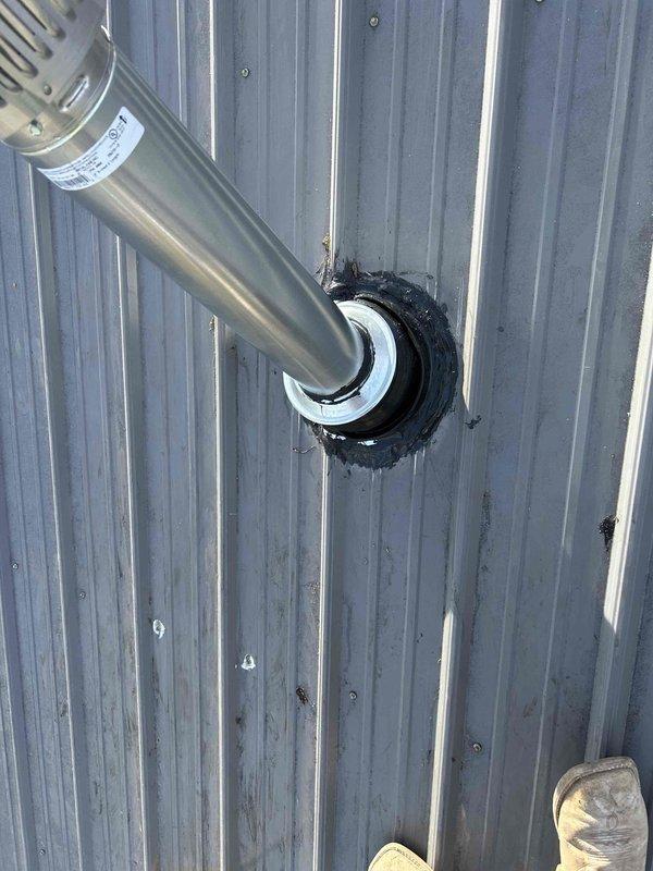 Performed warranty service to replace improper 3" furnace flue with correct 4" double wall piping, which eliminated condensation and leakage issues during furnace operation. Installation included new vent pipe, roof flashing, storm cap and collar with proper sealing. Verified complete system from furnace through roof penetration meets code requirements.