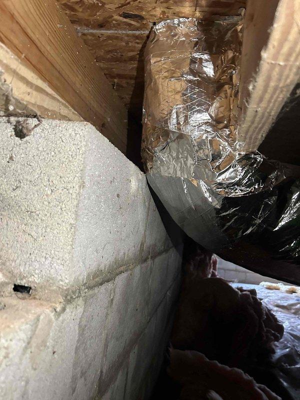 Completed insulation of all exposed metal ductwork in crawlspace including boots and panning per inspector requirements. Added proper wooden supports to duct system to replace webbing supports. All modifications were performed to meet code requirements for rough-in inspection approval.