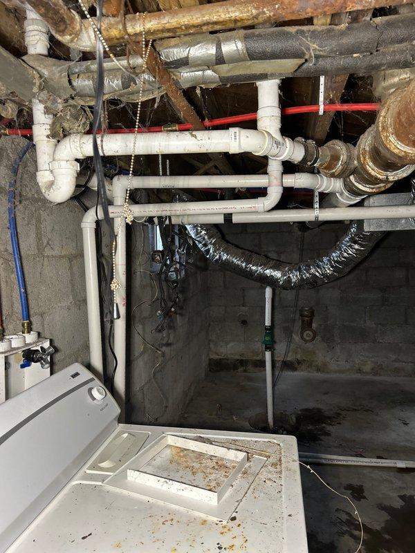Successfully relocated sump pump discharge line by coring through basement wall to create proper drainage into backyard, eliminating previous drainage issues. Installed bucket pump system for basement washing machine to connect directly to sewer line, providing appropriate wastewater management and preventing potential basement flooding.