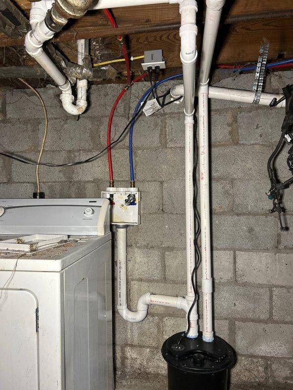 Successfully relocated sump pump discharge line by coring through basement wall to create proper drainage into backyard, eliminating previous drainage issues. Installed bucket pump system for basement washing machine to connect directly to sewer line, providing appropriate wastewater management and preventing potential basement flooding.