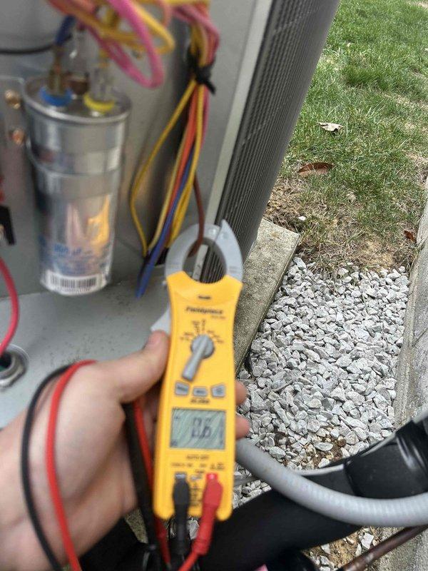 Performed Gold Level maintenance service on single-system heat pump/air handler located in attic. Inspected and tested capacitor (35/5 μF, 440VAC) using Fieldpiece multimeter with reading of 0.6 amps. System operating within normal parameters with all electrical connections secure.