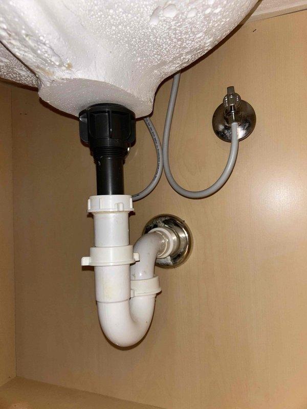Addressed water leak issues in multiple areas: repaired leaking sink flanges in kitchen and master bath, replaced faulty garbage disposal, fixed toilet refill kit, and corrected plumbing vent in attic by removing test balloon and reinstalling cap. Performed thorough inspection of sink P-trap and drain assembly showing signs of water damage. All affected areas were cleaned and restored to proper working condition.
