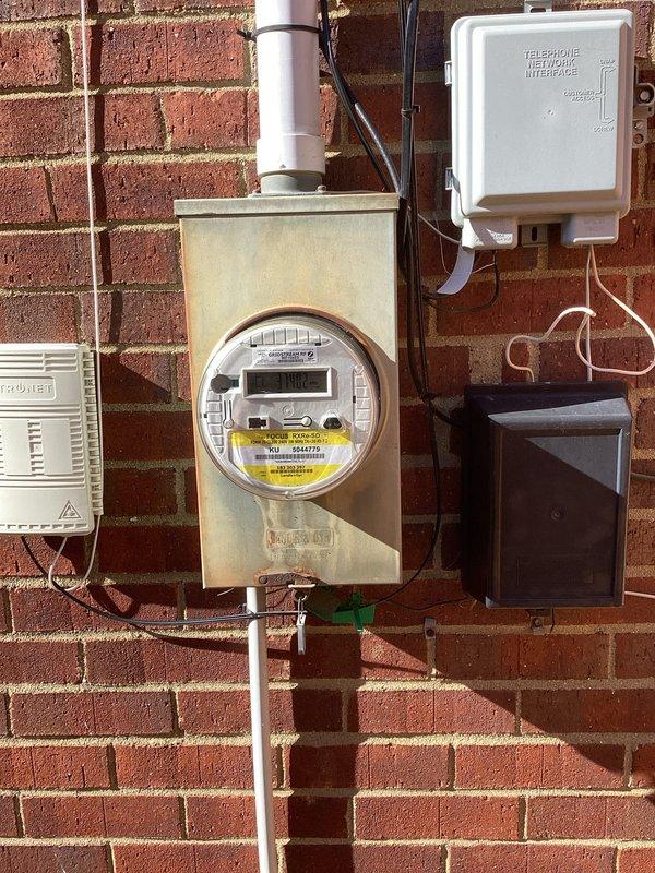 Conducted site assessment for generator installation, evaluating existing electrical infrastructure including meter setup and available connection points. Documented current utility configuration, including the telecommunications interface and junction boxes, to determine optimal placement for generator transfer switch and necessary modifications to the exterior wall junction area.