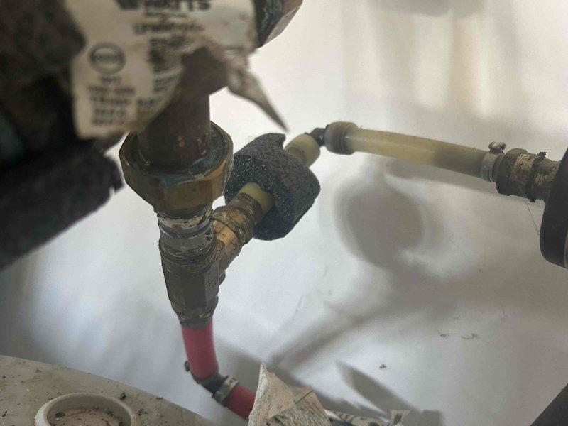 Conducted inspection of customer's water heater system to diagnose recurring annual leak. Examined plumbing connections including brass valves, copper piping, and insulated lines. Identified signs of corrosion at brass fittings and junction points that could be contributing to the persistent leakage issue. Recommended replacement of deteriorating components to prevent future water damage.