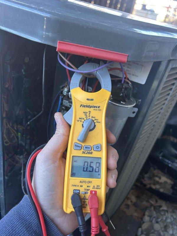 Conducted routine care plan tune-up on customer's heat pump/air handler system located in basement. Performed electrical diagnostic testing using Fieldpiece SC260 clamp meter, confirming proper amperage readings of 0.58. Verified thermostat functionality on Honeywell Home ProSeries which was operating correctly with heat set to 70°F and fan in auto mode.