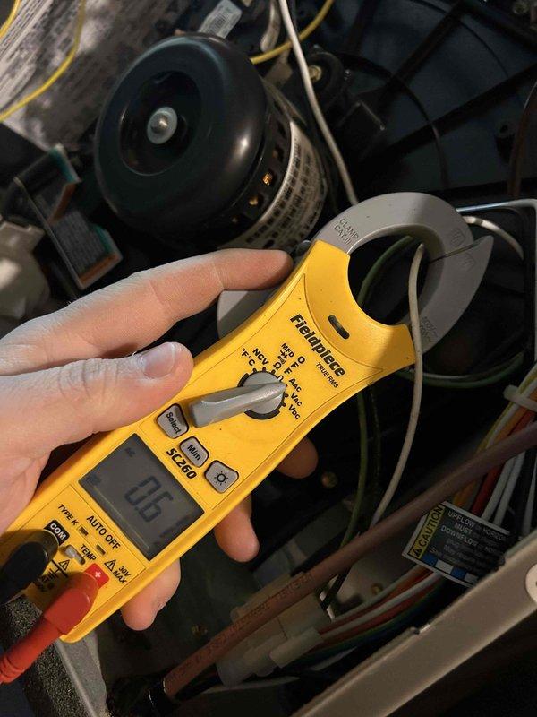 Performed Care Plan Tune Up on heat pump/gas furnace system located in laundry room off garage. Conducted visual inspection of burner assembly which appeared in functional condition, and measured electrical current draw at 0.6 amps during operation using Fieldpiece clamp meter. Equipment is easily accessible and operating within normal parameters.