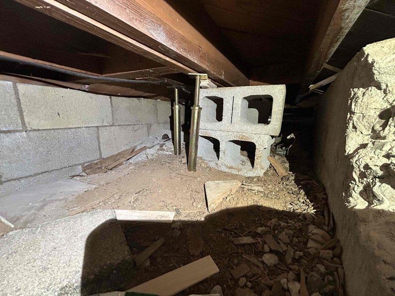 Performed annual Care Plan Tune Up on AC and gas furnace located in basement. Inspected crawl space area with exposed wooden joists and cinder block walls. Observed proper installation of equipment and cleared surrounding area of debris for optimal system performance.