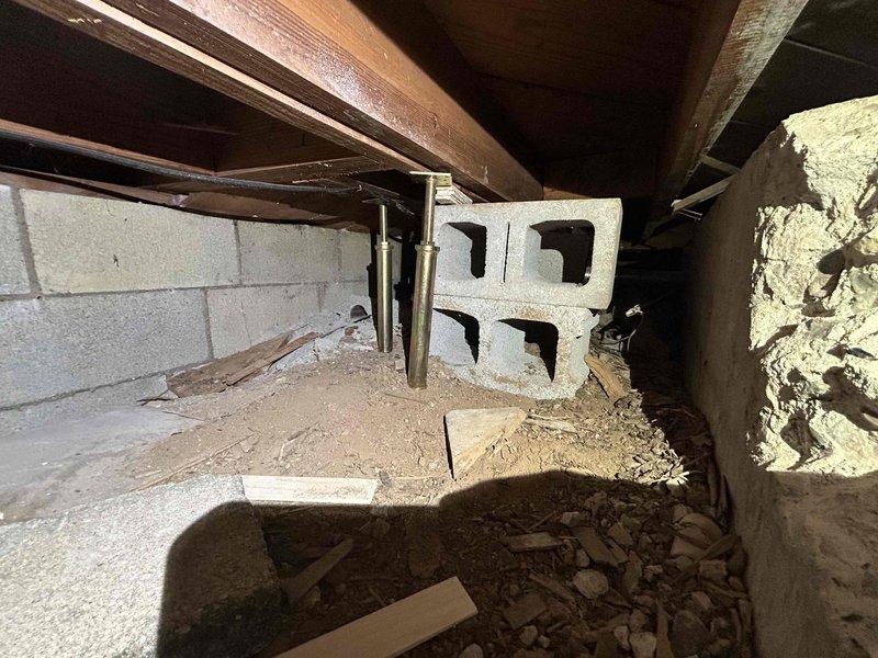 Performed annual Care Plan Tune Up on AC and gas furnace located in basement. Inspected crawl space area with exposed wooden joists and cinder block walls. Observed proper installation of equipment and cleared surrounding area of debris for optimal system performance.