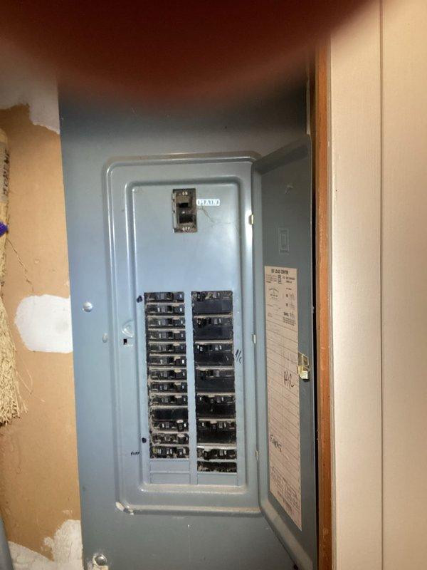 Conducted comprehensive assessment of existing electrical panel for generator installation compatibility. Documented current circuit breaker configuration and wiring conditions, noting older wiring with some disorganization. Panel inspection revealed available spaces for generator transfer switch integration while identifying necessary upgrades to accommodate additional load requirements.