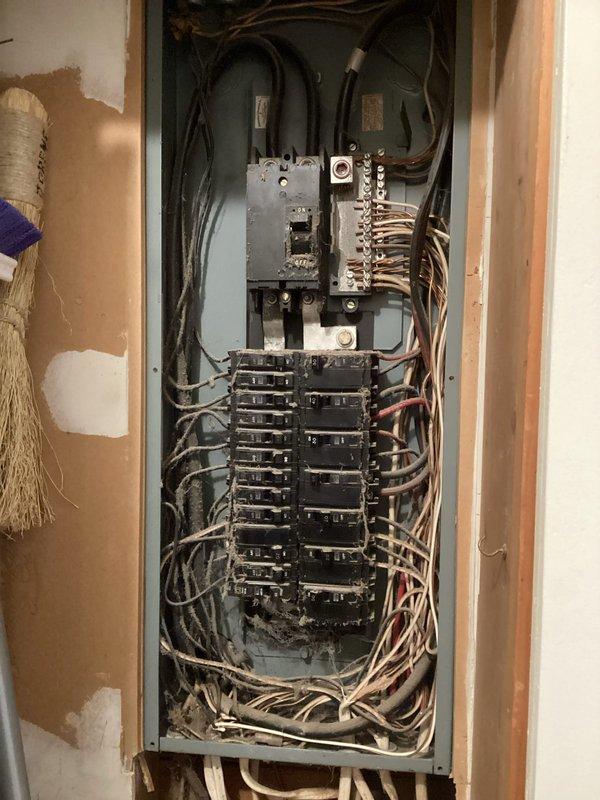 Conducted comprehensive assessment of existing electrical panel for generator installation compatibility. Documented current circuit breaker configuration and wiring conditions, noting older wiring with some disorganization. Panel inspection revealed available spaces for generator transfer switch integration while identifying necessary upgrades to accommodate additional load requirements.