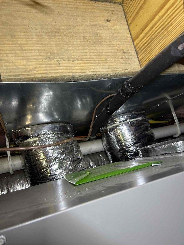 Inspected guest house #2 heating system in attic crawl space. Found improperly sized ductwork with inadequate clearances (measured 7-8 inches) between components. System efficiency compromised by existing insulation configuration. Identified and documented issues with metallic insulation on supply pipes that are contributing to the heating deficiency.