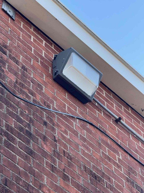 Conducted electrical estimate for hallway light replacement at church property. Inspected two exterior light fixtures - one cylindrical with a ribbed diffuser on brick wall and one rectangular black fixture with frosted panel mounted beneath soffit. Will recommend suitable replacement options and possible repair alternatives as requested by Pastor.