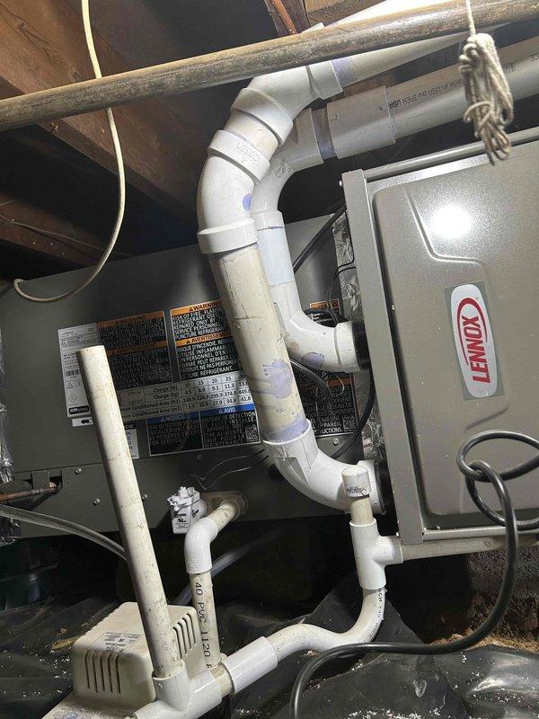 Completed warranty service on a newer 90% gas furnace installation to address persistent flue noise issues. Re-routed the fresh air intake and exhaust system, replacing the problematic front-mounted concentric kit with a flat low-profile concentric kit on the driveway side of the house. This modification ensures proper condensate drainage, adequate fall back to the furnace, and eliminates noise disturbance previously affecting the bedroom window area.