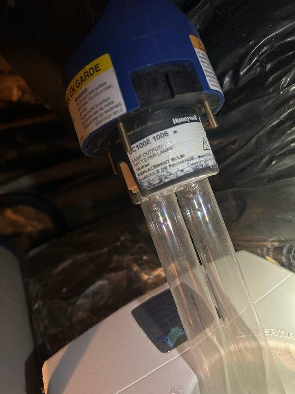 Performed scheduled Care Plan Tune Up on the heat pump/air handler system. Inspected the Honeywell C100JE 1006 UV lamp component in the system. Replaced the air filter with correct size 20x20x4 (actual size 19½×19½×3¾) and verified proper airflow direction. Confirmed UV lamp operation and safety warning labels are intact and visible.