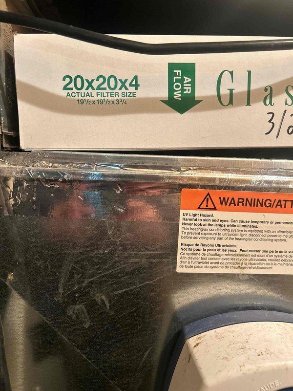 Performed scheduled Care Plan Tune Up on the heat pump/air handler system. Inspected the Honeywell C100JE 1006 UV lamp component in the system. Replaced the air filter with correct size 20x20x4 (actual size 19½×19½×3¾) and verified proper airflow direction. Confirmed UV lamp operation and safety warning labels are intact and visible.