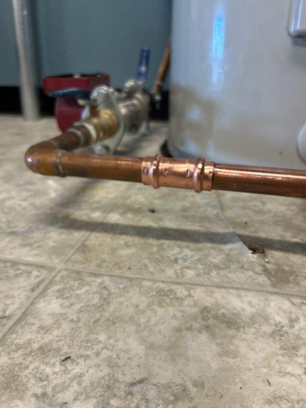 Successfully removed 80-gallon electric water heater and installed new 50-gallon tall electric water heater per specifications. Completed all necessary copper pipe connections with brass fittings, reconnected to existing water lines and electrical service, and verified proper operation with no leaks before departure. Disposed of old unit and filed required KY Division of Plumbing permit documentation.