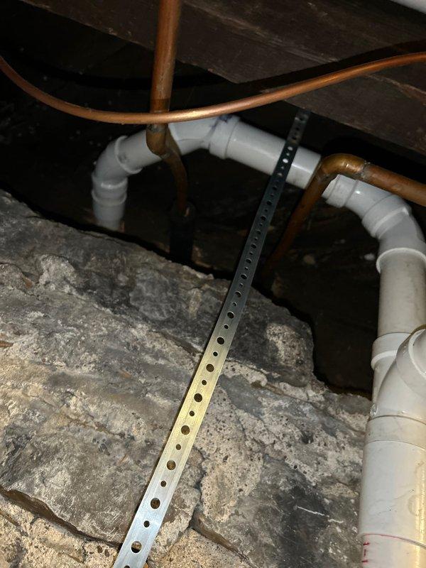 Cleared severely clogged kitchen sink drain that had complete blockage causing standing water. Inspected main drain line and clean-out access in basement. Removed obstruction and verified proper drainage restoration with full water flow.