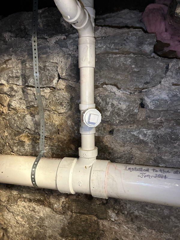 Cleared severely clogged kitchen sink drain that had complete blockage causing standing water. Inspected main drain line and clean-out access in basement. Removed obstruction and verified proper drainage restoration with full water flow.