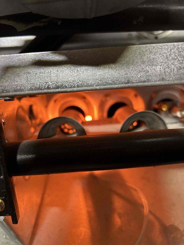 Responded to no heat service call for 13-year-old gas furnace. Upon inspection, found system locked out at thermostat. Diagnosed issue, restored proper operation, and verified normal flame sequence in burner assembly. System now functioning correctly with good combustion pattern observed.