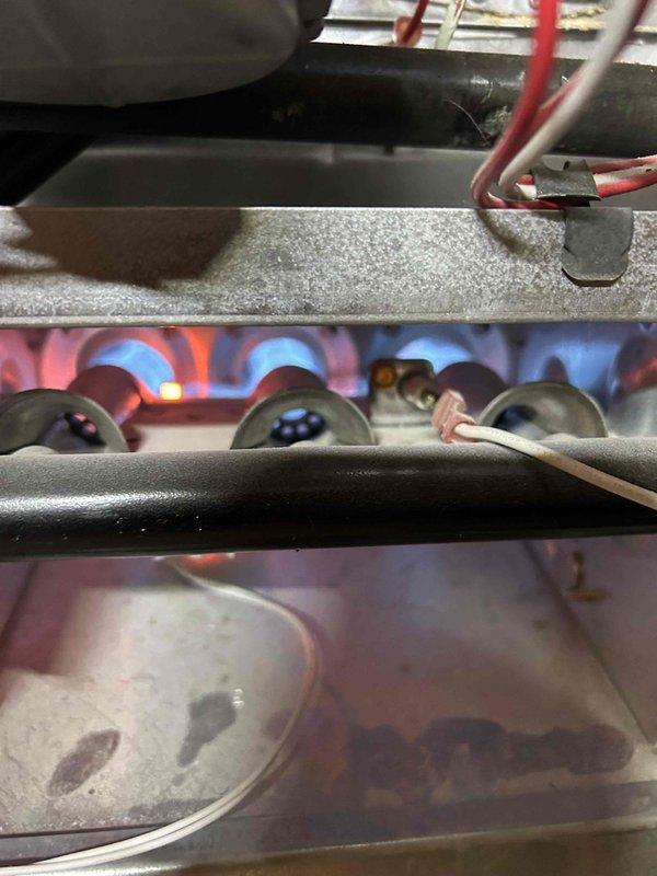 Responded to no heat service call for 13-year-old gas furnace. Upon inspection, found system locked out at thermostat. Diagnosed issue, restored proper operation, and verified normal flame sequence in burner assembly. System now functioning correctly with good combustion pattern observed.