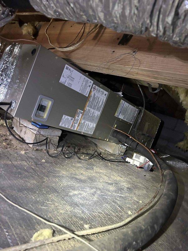 Performed annual Care Plan tune-up on heat pump/air handler system located in crawlspace. Inspected unit mounted on wooden platform with surrounding vapor barrier insulation and examined insulated ductwork for proper condition. Customer was advised on appropriate filter and humidifier maintenance requirements, with information provided for future replacement orders.