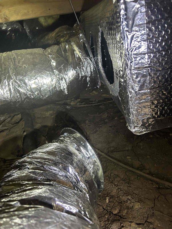 Performed annual Care Plan tune-up on heat pump/air handler system located in crawlspace. Inspected unit mounted on wooden platform with surrounding vapor barrier insulation and examined insulated ductwork for proper condition. Customer was advised on appropriate filter and humidifier maintenance requirements, with information provided for future replacement orders.