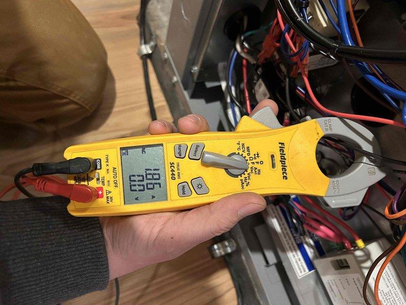 Responded to customer call regarding system issues during scheduled Care Plan Tune Up for geothermal heat pump system. Performed electrical testing with clamp meter, recording amperage readings of 96.8. Checked system pressure using DESCO gauge, ensuring proper operation parameters. Customer advised about washable filter maintenance for indoor air handler units located in basement and second floor closet.