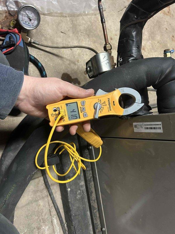 Responded to service call for reported gurgling sounds from geothermal unit. Conducted electrical testing using clamp meter, measuring current draw at 6 amps. Inspected system pressure using gauge, which registered approximately 30-35 PSI (within normal operating range). Determined air was present in the lines as suspected. Purged air from the system, restoring proper circulation and eliminating the gurgling noise.
