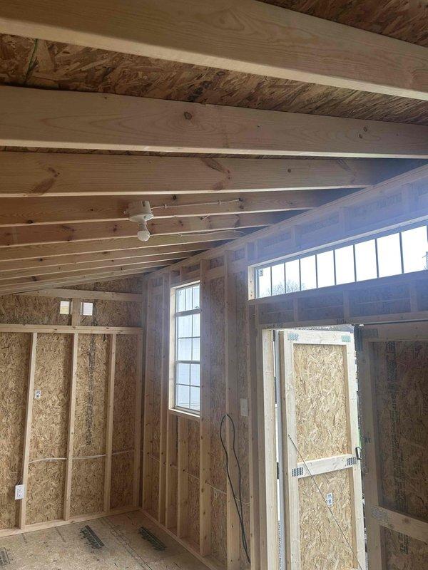 Completed installation of electrical components in a framed structure including one GFCI outlet, one duplex outlet, one single pole switch, and one keyless light fixture with bulb. Installed SJ cord with male cord cap, connecting all fixtures according to Pemberton 10x201 specifications and ensuring proper function of all components.