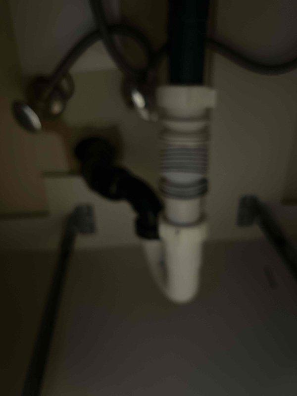 Inspected under-sink plumbing system and identified improper accordion-style flexible drain trap that was collecting debris and causing drainage restrictions. Recommended replacement with standard code-compliant P-trap assembly. Also evaluated exterior hose bib that customer reported as non-operational, potentially due to freezing damage from recent low temperatures.