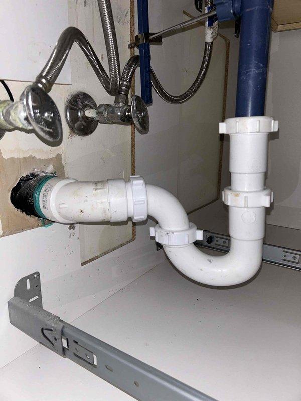 Inspected under-sink plumbing system and identified improper accordion-style flexible drain trap that was collecting debris and causing drainage restrictions. Recommended replacement with standard code-compliant P-trap assembly. Also evaluated exterior hose bib that customer reported as non-operational, potentially due to freezing damage from recent low temperatures.