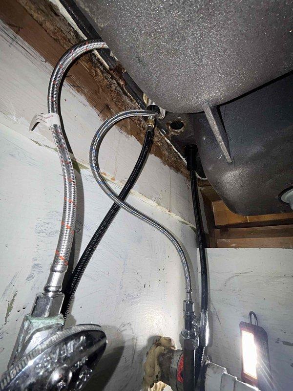 Successfully installed customer-supplied kitchen faucet with new supply lines, replacing the previous black faucet with curved neck and separate spray attachment. Completed all connections to existing water system, tested operation thoroughly, and verified zero leaks upon completion.